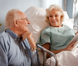 eldery man visitng his wife in the hosptial