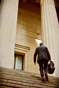 lawyer climbing steps to courthouse